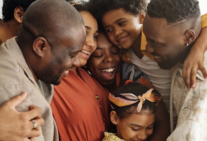 Heartwarming family group hug showcasing affection and togetherness indoors.