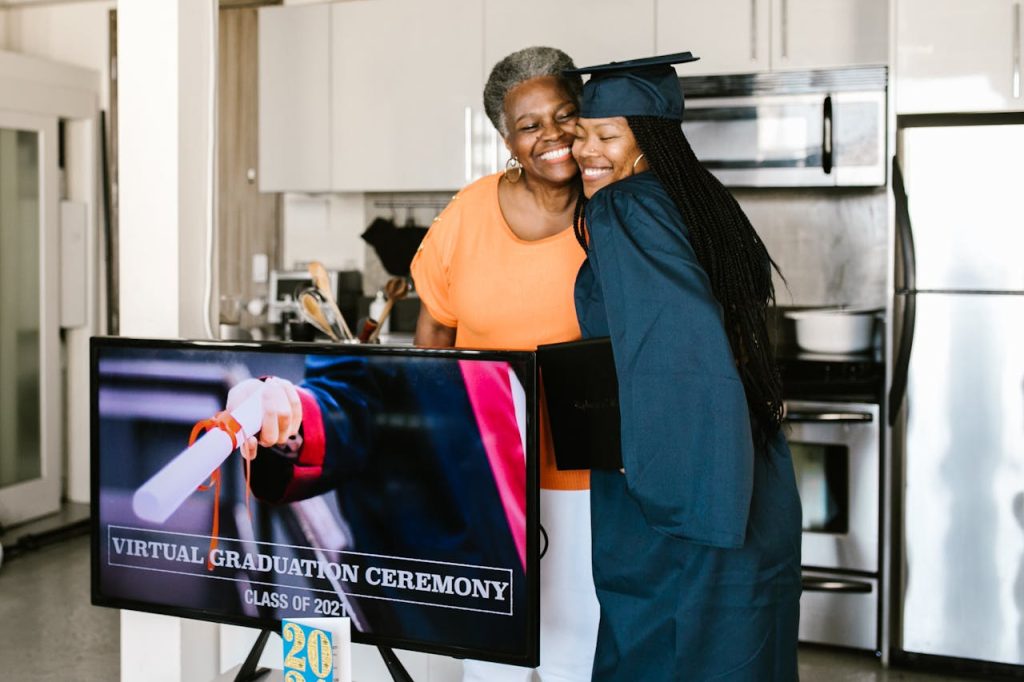 A joyful moment of virtual graduation celebration in a modern kitchen setting.